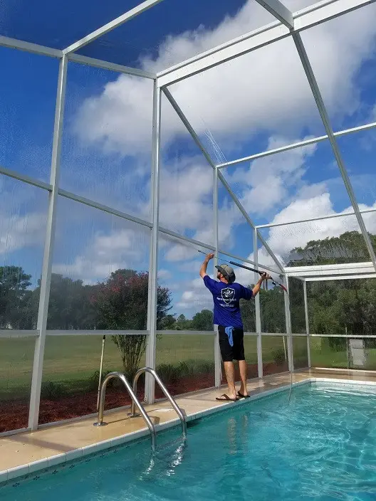 Pool enclosure cleaning with soft wash system to protect screens and aluminum